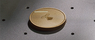 Image of a coin being laser engraved